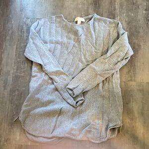 Michael Kora Cozy Gray Sweater with zipper detail on sides.